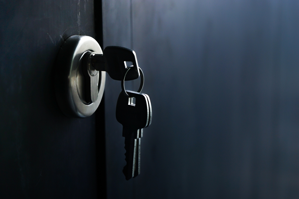 three keys with one engaged on a lock