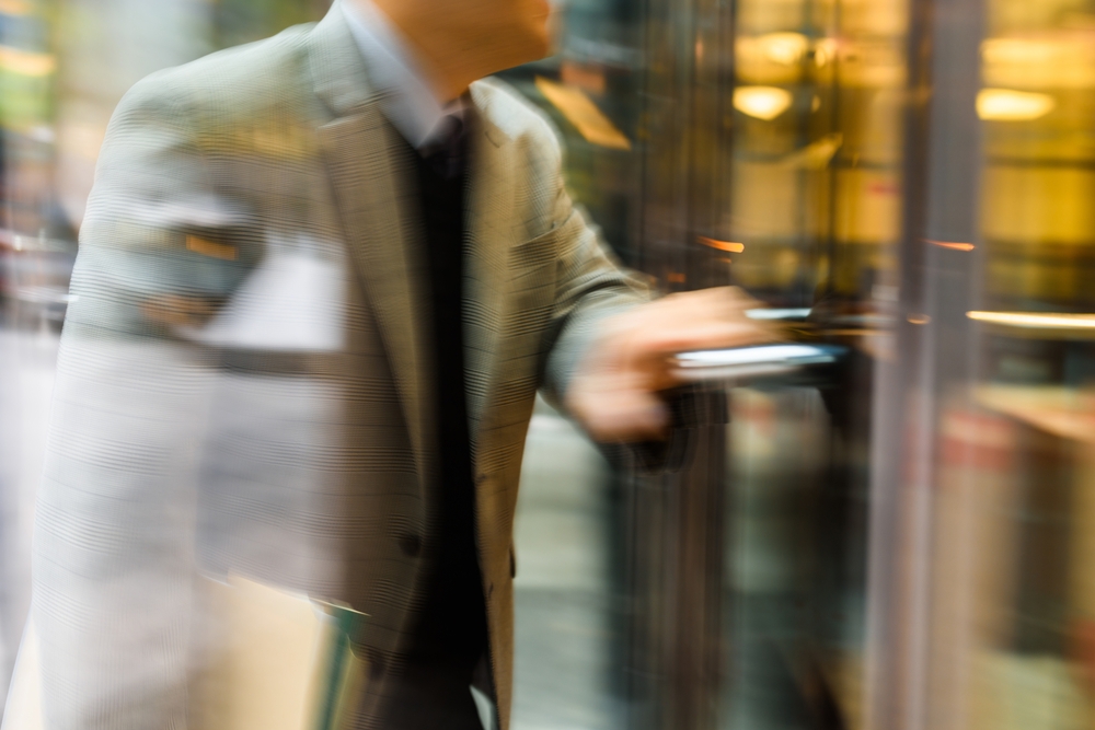 a man entering a glass door