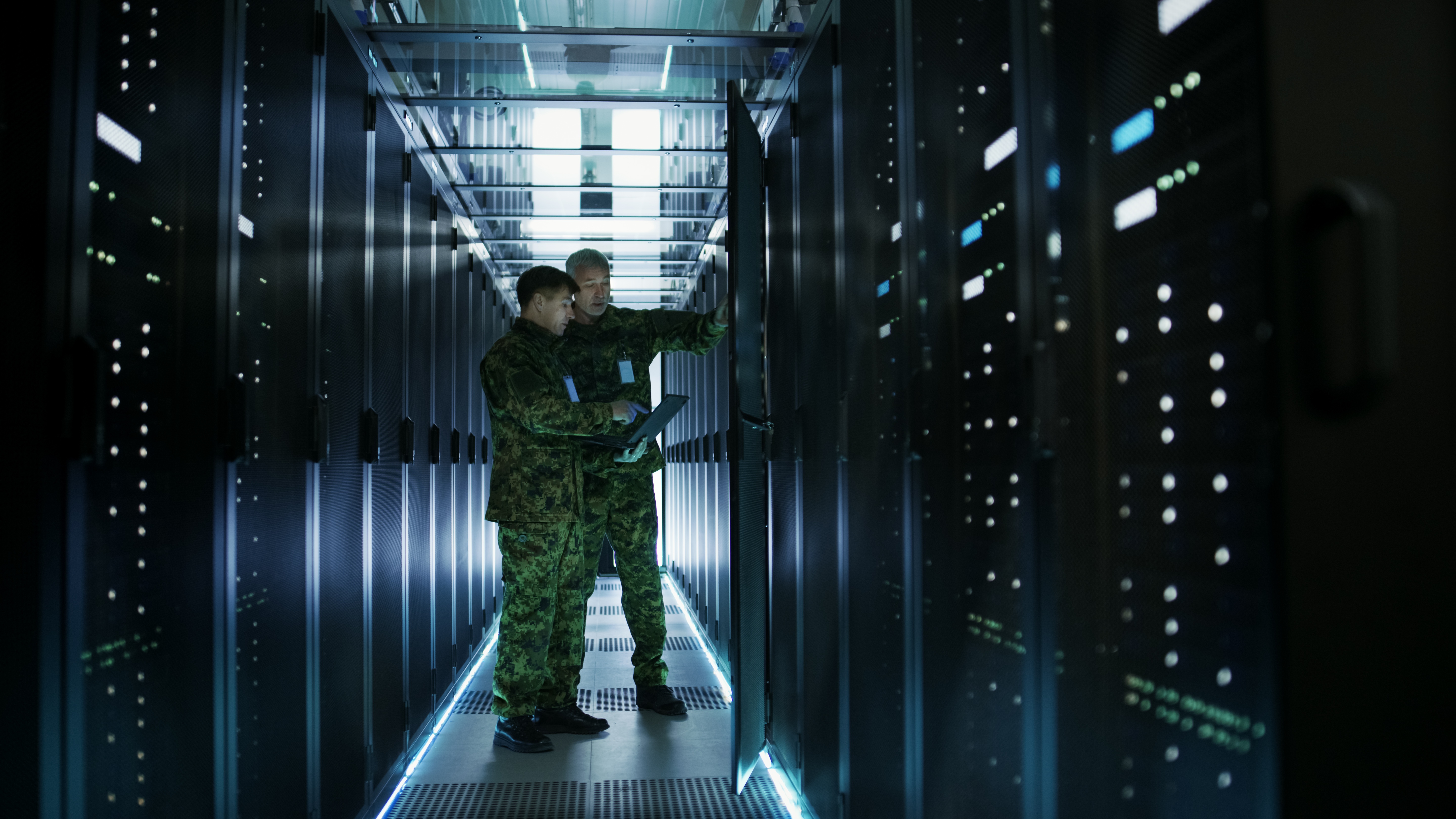 two men working on a control panel